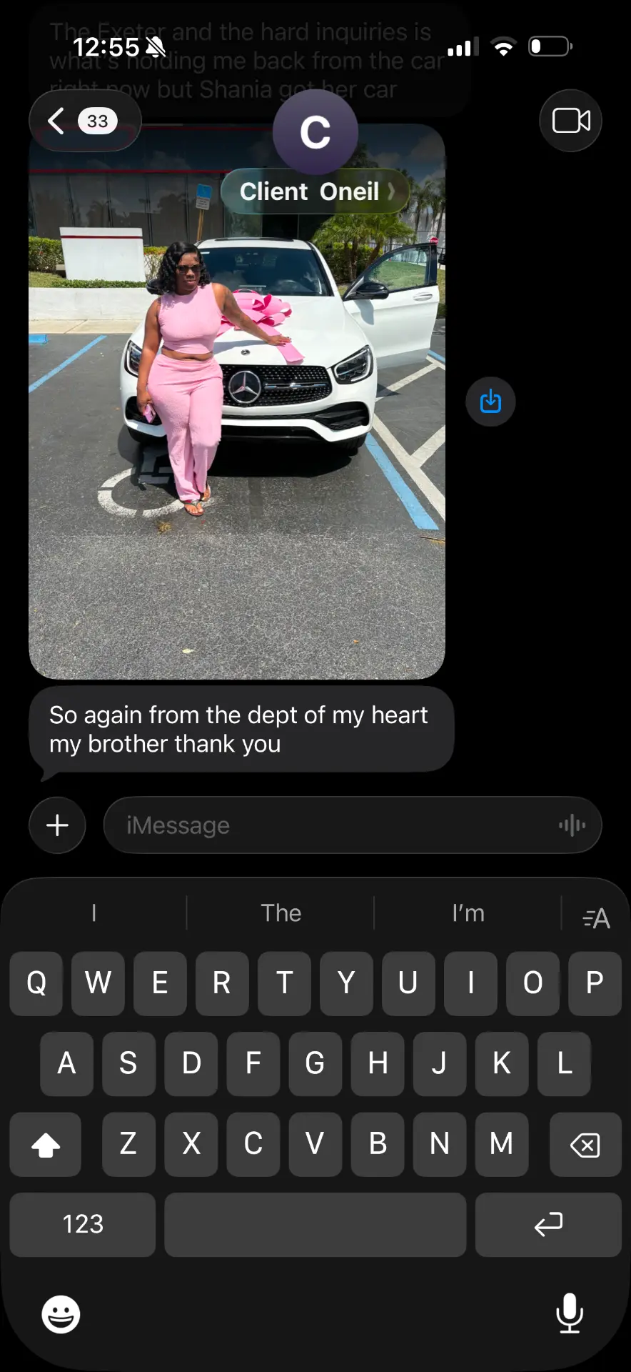 Client photo next to a new vehicle after working on their credit